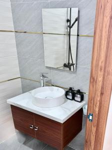 a bathroom with a sink and a mirror at Golden Lotus Hotel in Buôn Hồ