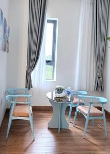 a room with tables and chairs and a window at Golden Lotus Hotel in Buôn Hồ +51 photos
