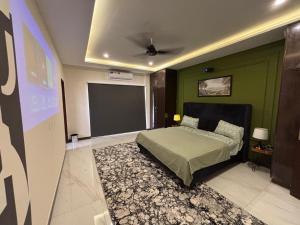 a bedroom with a bed and a projection screen at Spacious Apartment by Urban Residence in Multan