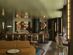 a lobby with a couch and chairs and a bar at Hannah St Hotel Melbourne in Melbourne