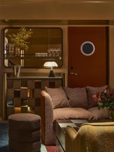 a living room with a couch and a table at Hannah St Hotel Melbourne in Melbourne +66 photos