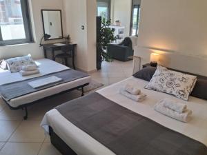 a bedroom with two beds and a living room at Alba - Open Plan Apartment in Artemida