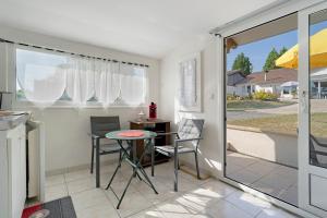 a small kitchen with a table and chairs in a room at Le Bois Du Mas in Saint-Aulaye +30 photos