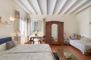 a living room with two beds and a table at Le Bois Du Mas in Saint-Aulaye