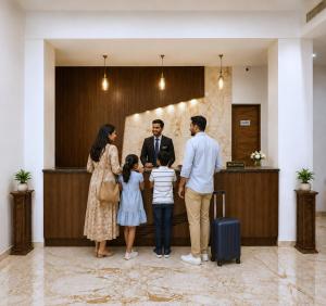 a family standing in a lobby with their luggage at Red Tullip Md Valley Resort & Spa - Luxury Resort With Swimming Pool, Udaipur in Udaipur +30 photos