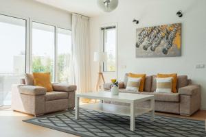 a living room with a couch and a table at 3BR Panoramic Sea View Villa with Private Pool by Cyprus Horizons in Pissouri