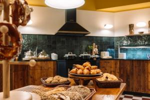 a kitchen with a table with baskets of bread at HENRI Hotel Garmisch-Partenkirchen in Garmisch-Partenkirchen