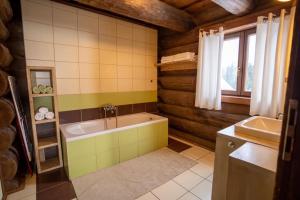 a bathroom with a tub and a sink at Chalet Vancouver in Donovaly +11 photos