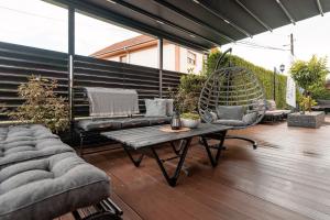 a patio with a couch and a chair and a table at Apartments Vidanovic in Ohrid