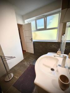 a bathroom with a white toilet and a window at House by the River in Plitvica Selo +58 photos
