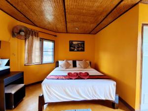 a bedroom with a bed with red roses on it at The Countryside Pai in Pai