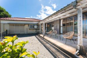 a patio of a house with chairs and a table at Azure Kawatana in Mitsugoe