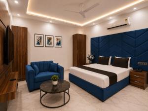 a bedroom with a bed and a couch and a table at Hotel Amar Raja in Kurukshetra
