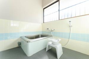 a bathroom with a toilet and a bath tub at Azure Kawatana in Mitsugoe +51 photos