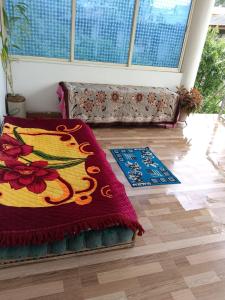 a living room with a couch and a rug at Sushils Bed and Breakfast in Port Blair +15 photos