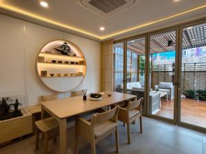 a dining room with a table and chairs at Tatami Hotel Phuket in Ban Ket Ho