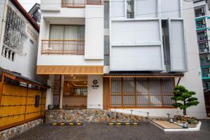 an external view of a building in a city at Tatami Hotel Phuket in Ban Ket Ho