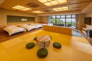 a large room with three beds and a table at 山荘 風の杜 Sanso Kazenomori in Minoo +85 photos