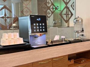 a cash register with a calculator on a counter at Grande Centre Point Ploenchit in Bangkok