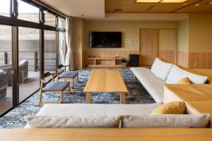 a living room with a couch and a table at 山荘 風の杜 Sanso Kazenomori in Minoo
