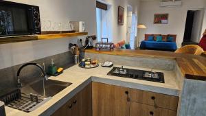 a kitchen with a sink and a counter top at Le Jardin Suffren LOFT in Jāmb +14 photos