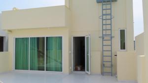 a room with a ladder next to a building at The Oceanview Grand at Hulumale and Male in Hulhumale