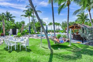 a couple laying in a hammock by the pool at a resort at Peninsula Villa Boat Dock Heated Pool Sunset Point in Islamorada
