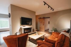 a living room with two couches and a fireplace at Apartments Vidanovic in Ohrid