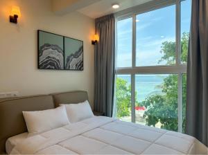 a bedroom with a bed and a large window at The Oceanview Grand at Hulumale and Male in Hulhumale