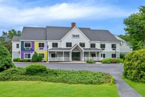 a large white house with a colorful at Spark by Hilton Brunswick in Brunswick