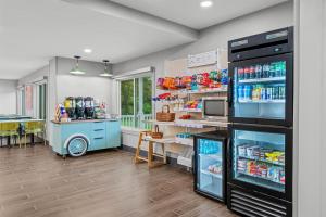 a store with a refrigerator and a table in a room at Spark by Hilton Brunswick in Brunswick