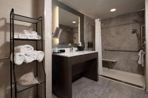 a bathroom with a sink and a shower and a tub at The Strathallan Rochester Hotel & Spa, Tapestry by Hilton in Rochester +76 photos