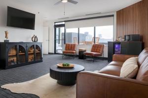 a living room with a couch and a table at The Strathallan Rochester Hotel & Spa, Tapestry by Hilton in Rochester