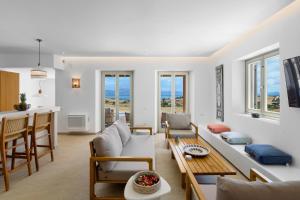 a living room with a couch and a table at Asana Villas by Raise in Márpissa