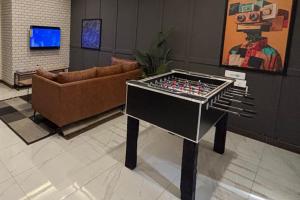 a living room with a table and a couch at Spacious Apartment by Urban Residence in Multan