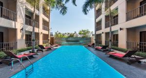 a swimming pool in the middle of a building at The Cottage Suvarnabhumi in Lat Krabang