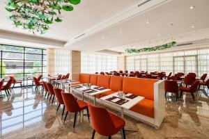 a restaurant with tables and chairs in a room at The Amman Landmark Hotel in Amman