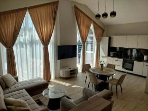 a living room with a couch and a table at Sweet villa Palanga in Palanga