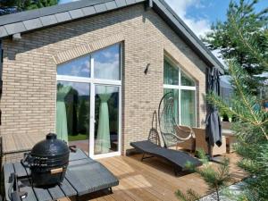 a patio with a grill and a bench on a deck at Sweet villa Palanga in Palanga