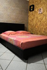 a bed sitting in a room with at Bungalow Le Cocotier in Sainte-Rose