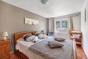 a bedroom with a bed with pillows on it at Appartement Type F4 in Maurens +16 photos