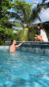 a man and a woman sitting in a swimming pool at Marine Beach Hotel in Cartagena de Indias +18 photos