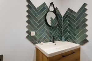 a bathroom with a sink and a mirror on the wall at Maison Mendi Borda Pays Basque in Larribar-Sorhapuru +12 photos