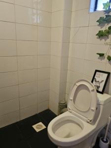 a bathroom with a toilet with the lid up at DSTAY HOMEs in Eldoret