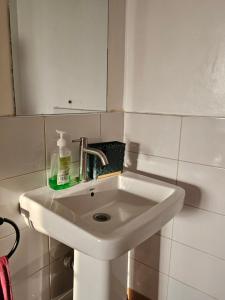 a white sink in a bathroom with a mirror at DSTAY HOMEs in Eldoret
