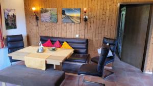 a dining room with a wooden table and chairs at Ferienhaus Bambach in Fladungen