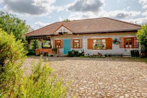 a small white house with a red roof at Zagroda w Puszczy in Białowieża