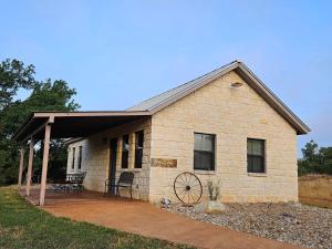 a small brick house with a large porch at Breezy Hills Cottages - Moonlight Cottage in Fredericksburg