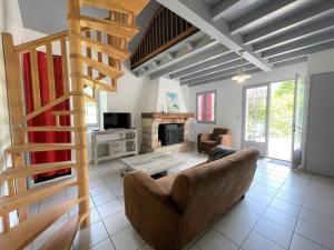 a living room with a couch and a fireplace at Elizako bidea in Mendive