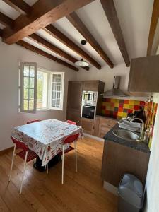 a kitchen with a table and a sink in it at Elizako bidea in Mendive +14 photos